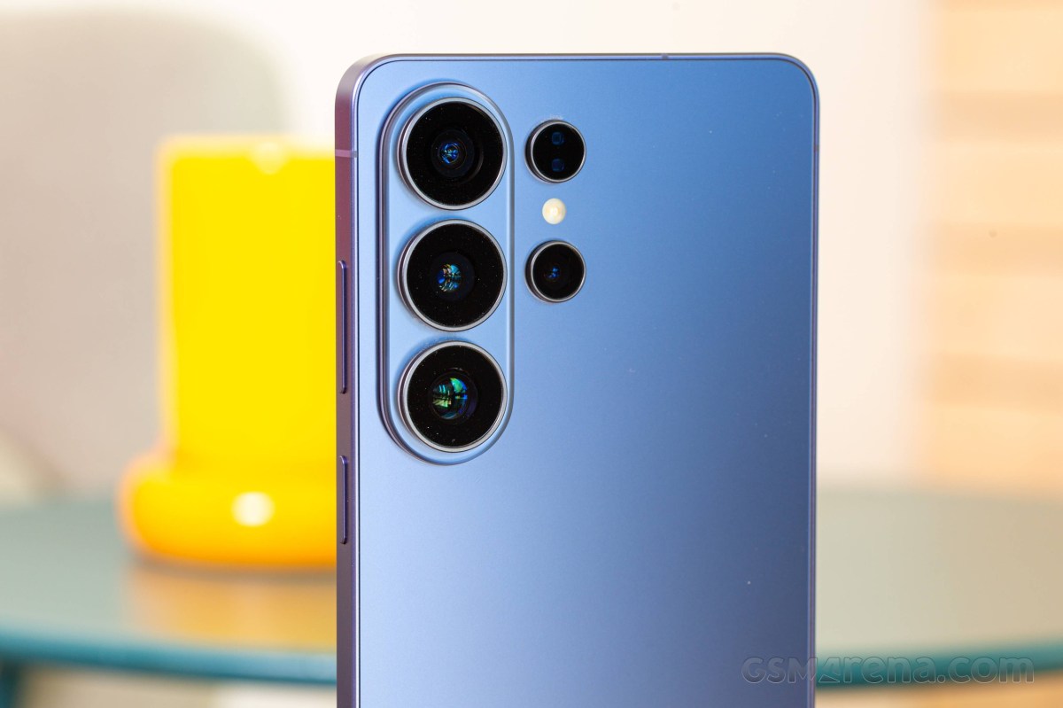 Blue smartphone back with a vertical triple-camera array on the left side and a circular flash in the middle group, photographed from a slight angle.