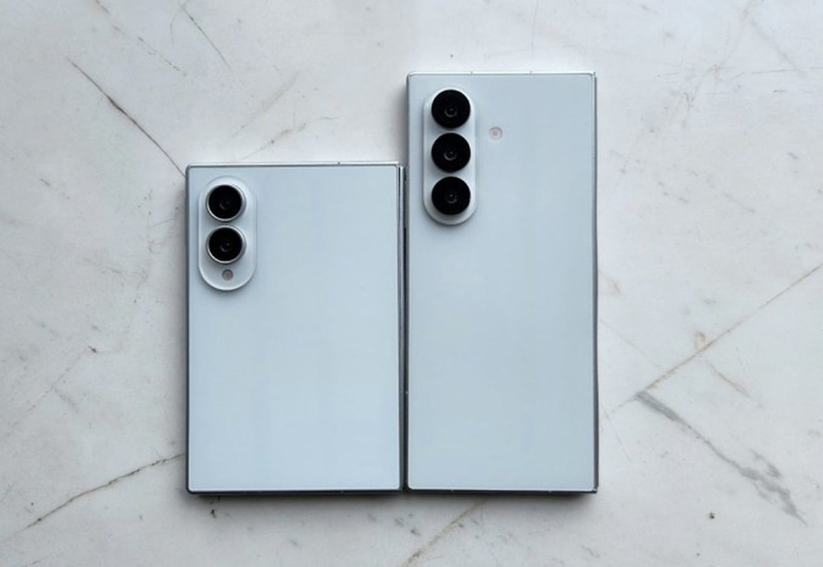 Two gray smartphones on a marble surface, left with two rear cameras and right with three cameras.