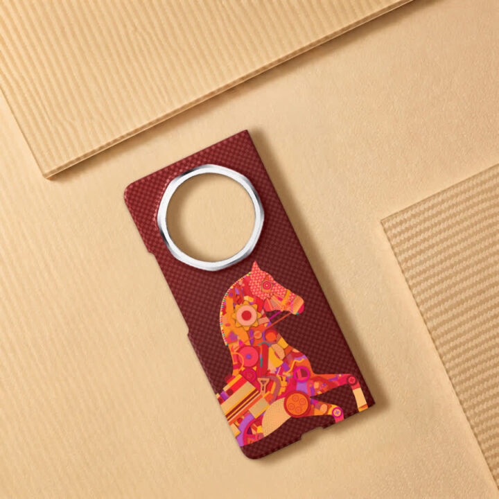 Colorful decorative door hanger tag with a bright horse mosaic design on a dark red background, placed on cardboard boxes.