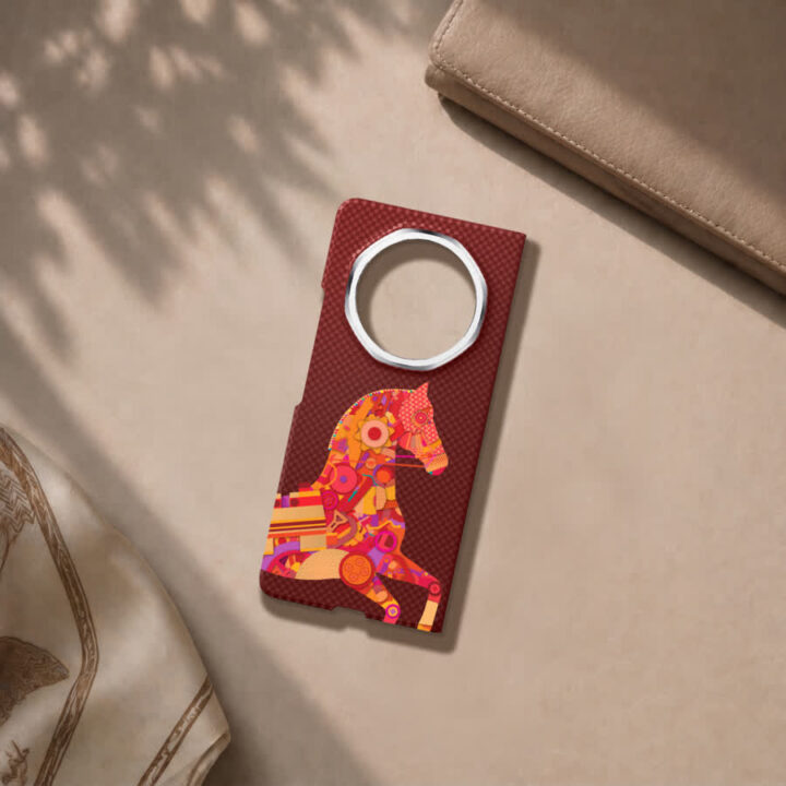 Red textured luggage tag with a circular metal ring slot and a colorful mosaic horse illustration on the tag surface.”,