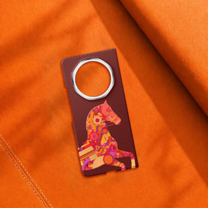 Brown textured tag with a metal ring for a keychain and a colorful abstract horse graphic on orange fabric.