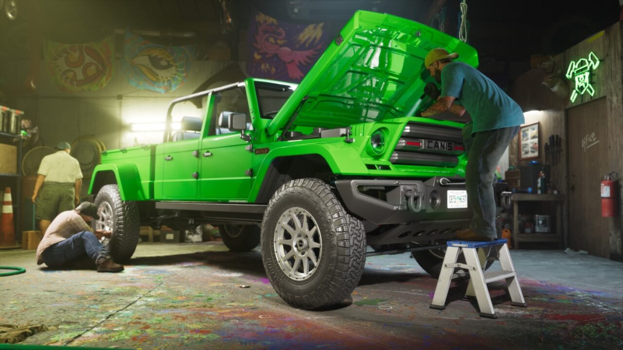 Bright Green Jeep Wrangler with the Hood Open Being Repaired in a Cluttered Workshop As a Mechanic on a Step Stool Works Under the Hood Another Tech on a Wheel Nearby