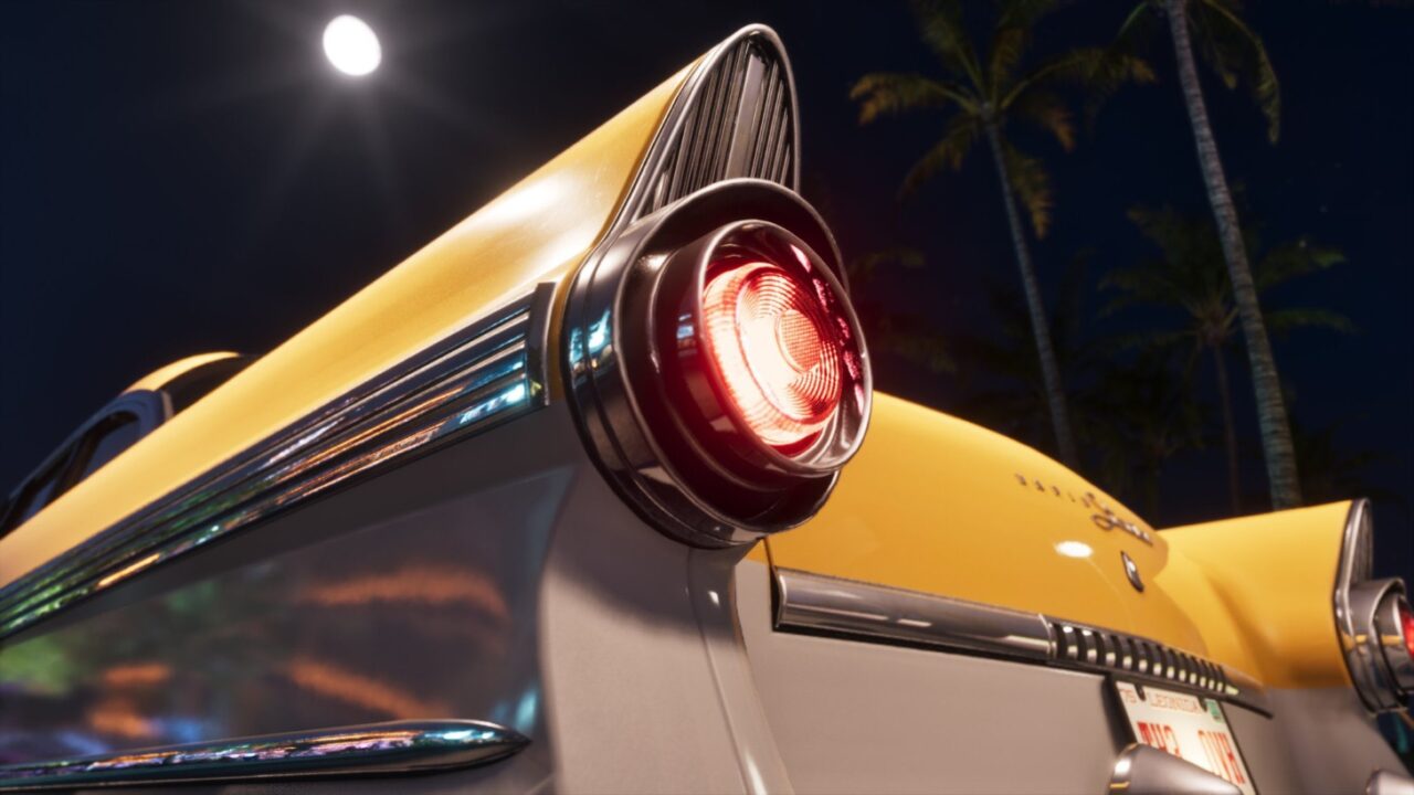 Close up of a Vintage Cars Glowing Red Taillight and Yellow Fin at Night Beside Palm Trees in the Background
