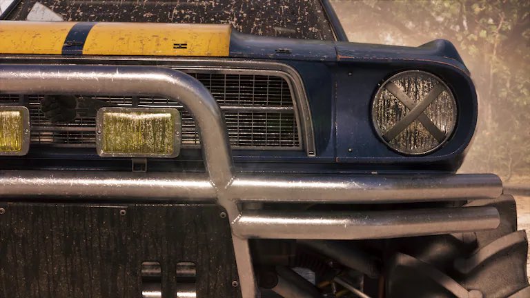 Front View of a Dusty Blue Vintage Suv with a Chrome Bumper and a Round Headlight Taped with an X Yellow Stripe on the Hood
