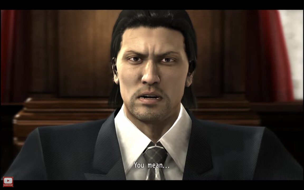 Close up of a Man in a Dark Suit Speaking in a Formal Setting with the Subtitle 'you Mean' Shown at the Bottom informative Video Still