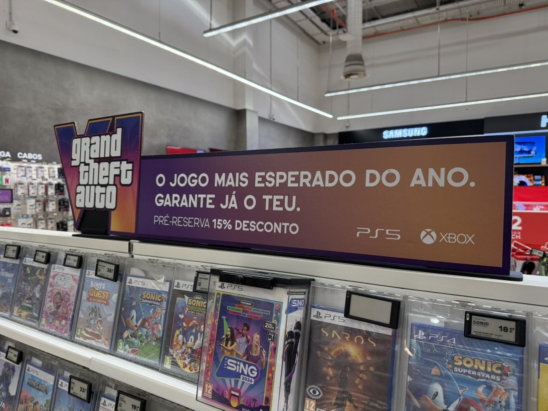 Promotional Store Sign for Grand Theft Auto with Preorder Offer 15 Off for Ps5 and Xbox in a Game Aisle