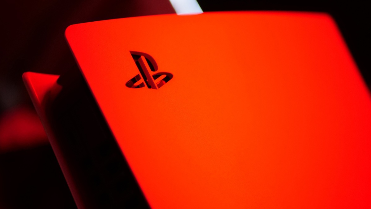 Close up of a Bright Red Laptop Lid with the Black Playstation Logo Against a Dark Background