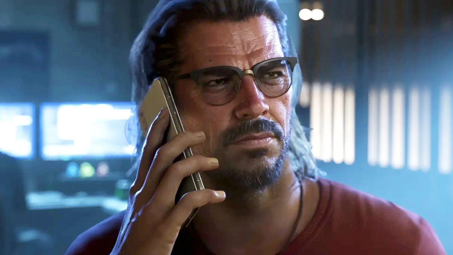 Bearded Man with Glasses on a Phone Call in a Dim High tech Control Room