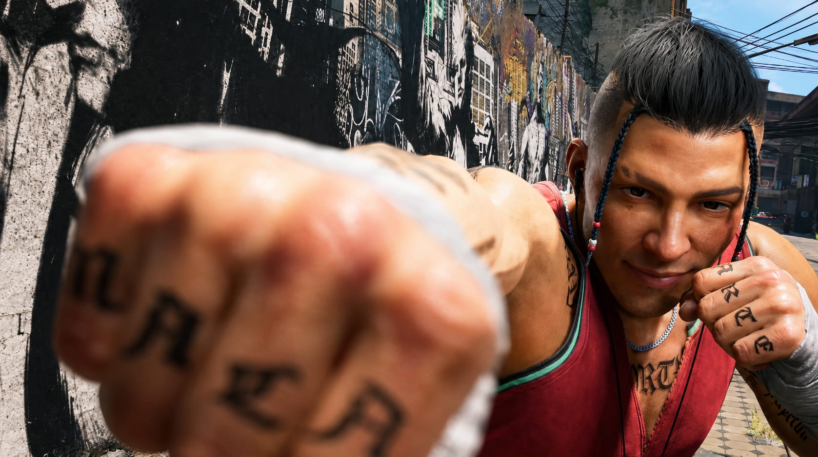 Man with Braided Hair and Tattoos Throws a Punch Toward the Camera in an Urban Alley with a Graffiti covered Wall Behind Him