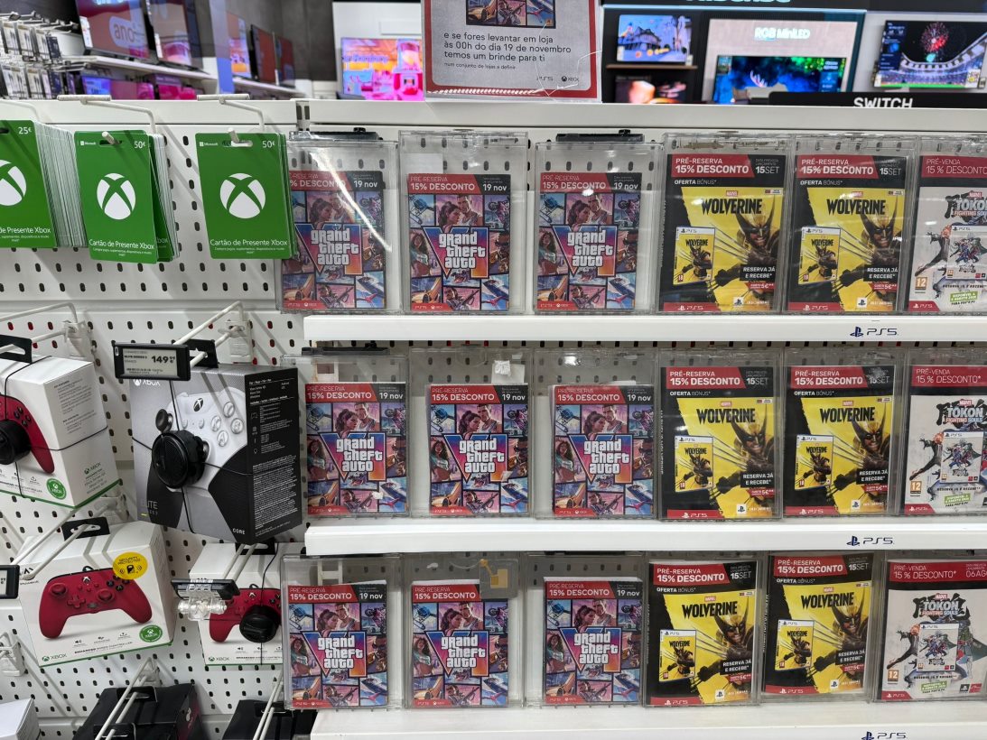 Retail Display of Video Game Cases Including Grand Theft Auto V and Wolverine with Green Xbox Gift Cards on the Left