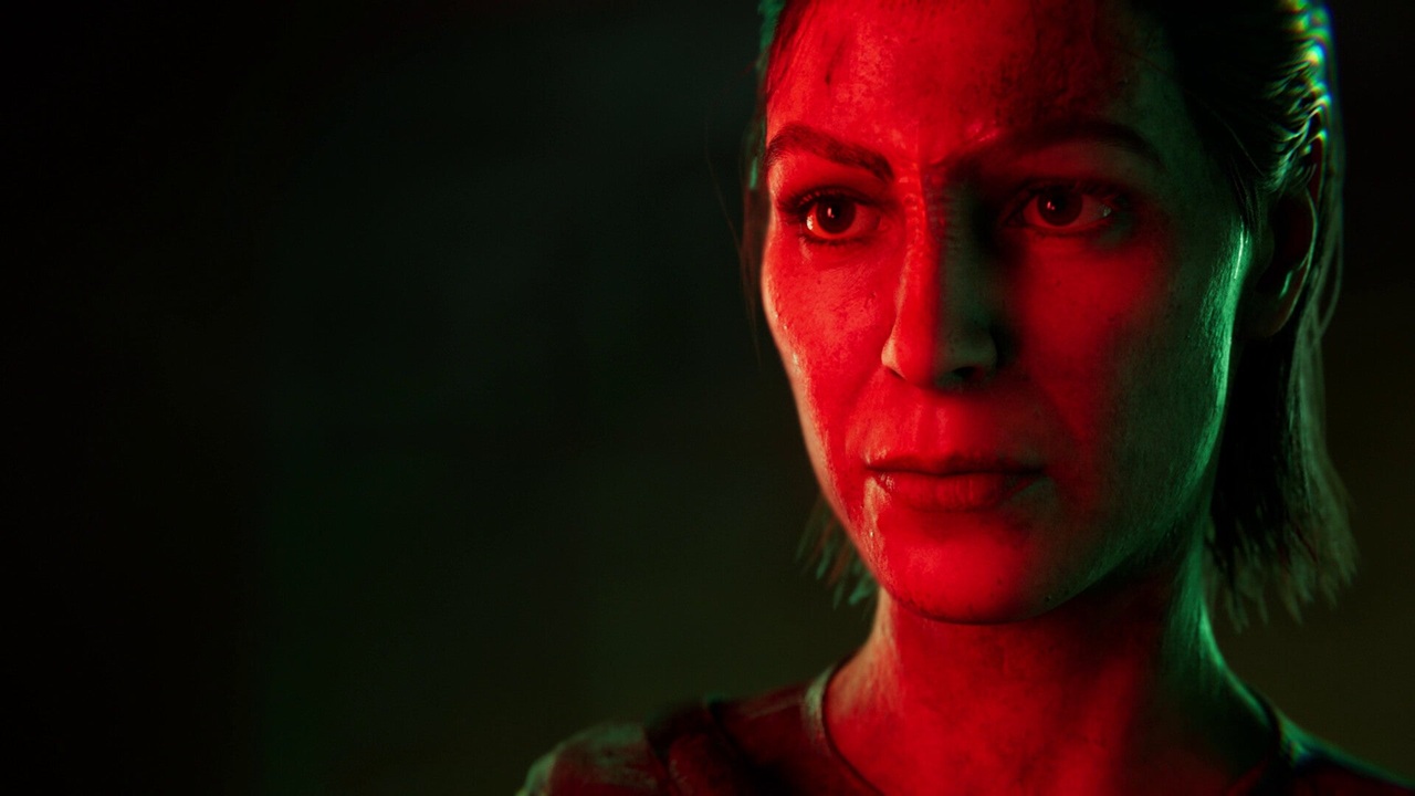 Close up of a Woman with a Tense Expression Illuminated by Red and Green Lighting Against a Dark Background Creating a Dramatic Mood