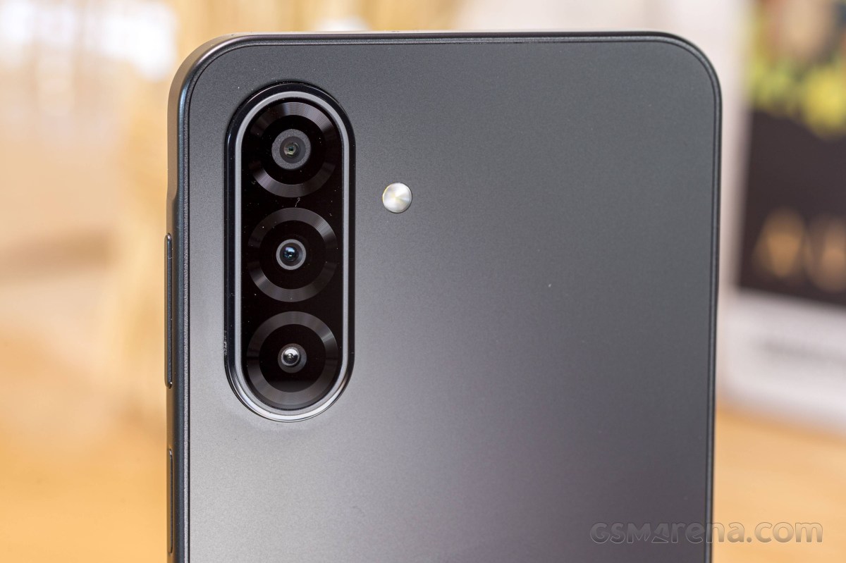Back of a smartphone showing a vertical triple-camera module with an LED flash.