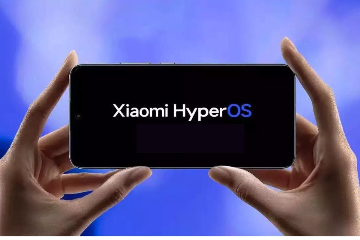 Hands holding a smartphone displaying the Xiaomi HyperOS logo on a black screen against a blue background.