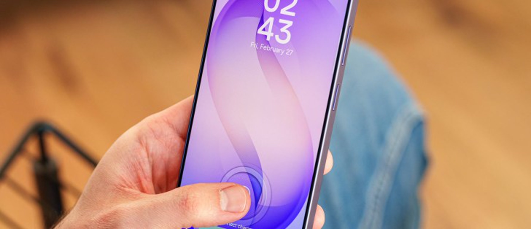 Close-up of a hand holding a smartphone with a purple screen and a fingerprint scan icon on the display.
