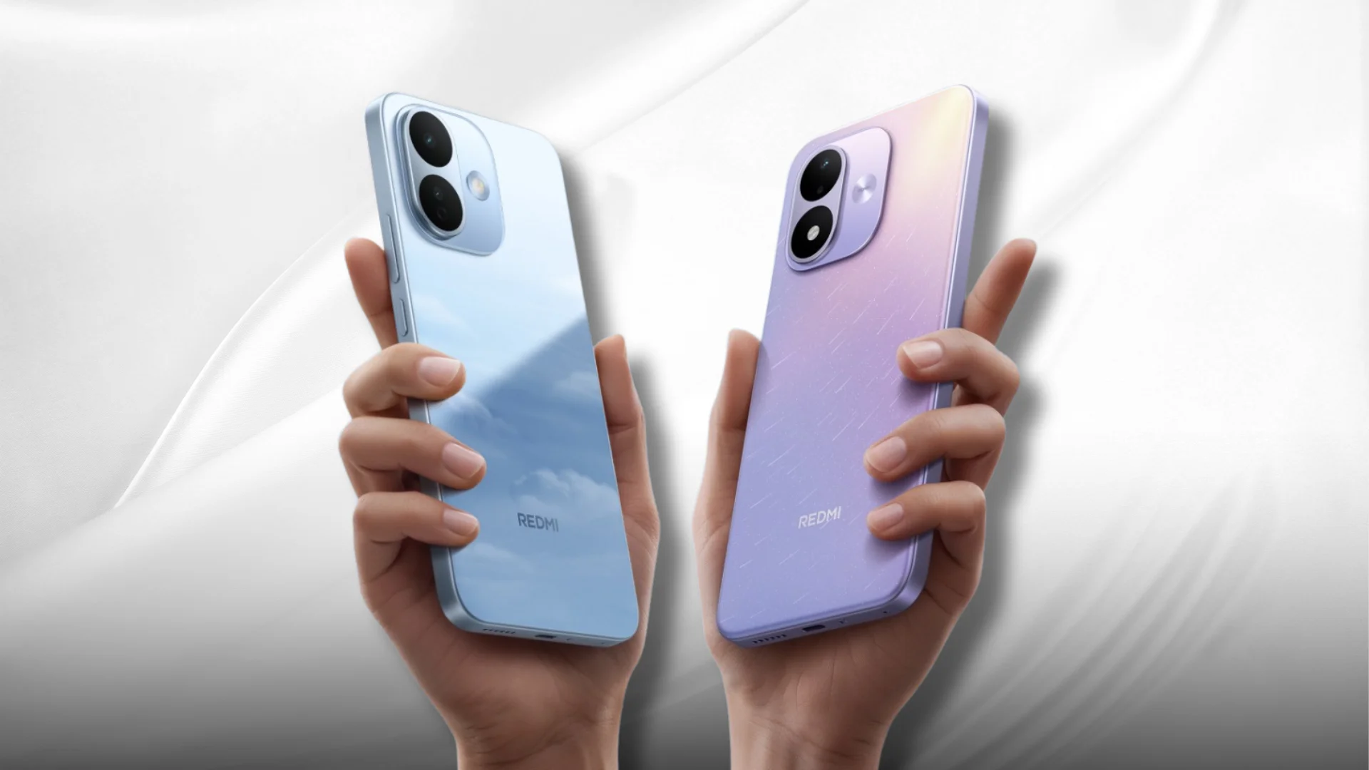 Two Redmi smartphones, one blue and one lavender, are held by hands against a pale background.