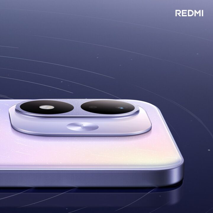 Close-up of a Redmi smartphone back with a dual large camera module and an iridescent gradient finish, Redmi logo visible in the top-right.