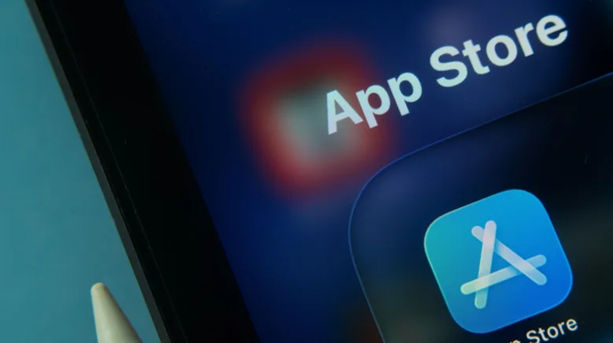 Close-up of a smartphone screen displaying the App Store app icon with the text 'App Store' nearby on a blue background.