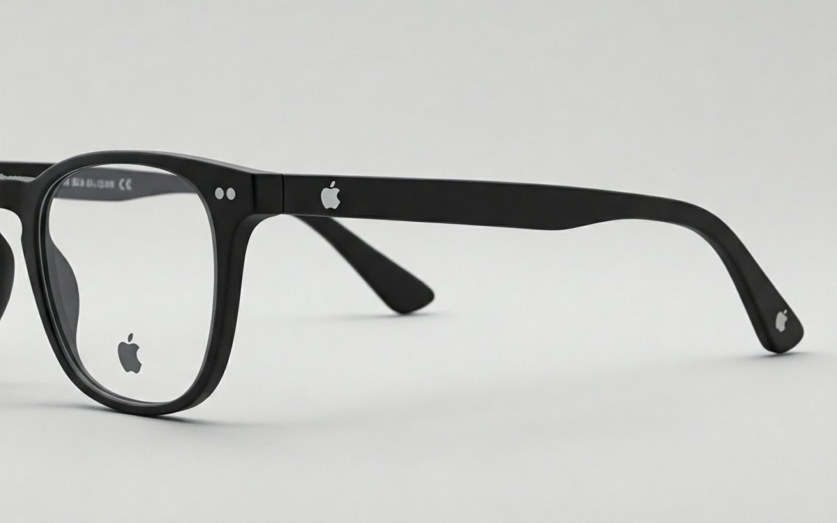 Black plastic eyeglasses with Apple logo on the temple, close-up view of the frame and left lens visible