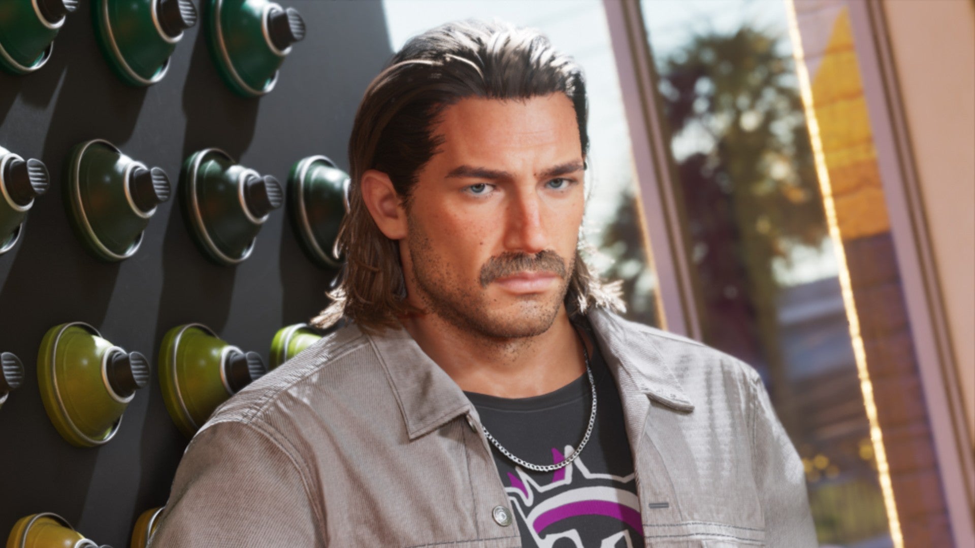 Man with Slicked back Dark Hair and Stubble Standing Beside a Wall with Round Green Knobsvent like Dials