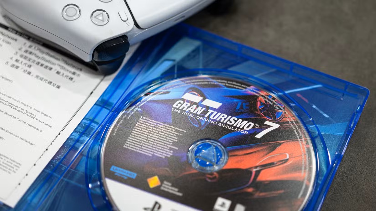 Gran Turismo 7 Game Disc in a Blue Case with a Printed Manual Nearby