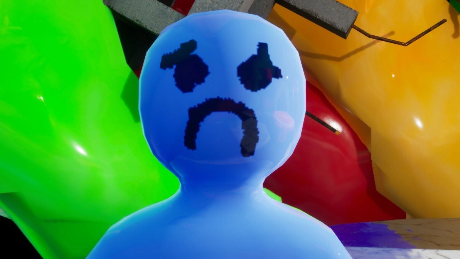 Blue Inflatable Figure with a Sad Face Drawn in Dark Blue Set Against Bright Green and Yellow Balloons with a Red Element in the Background