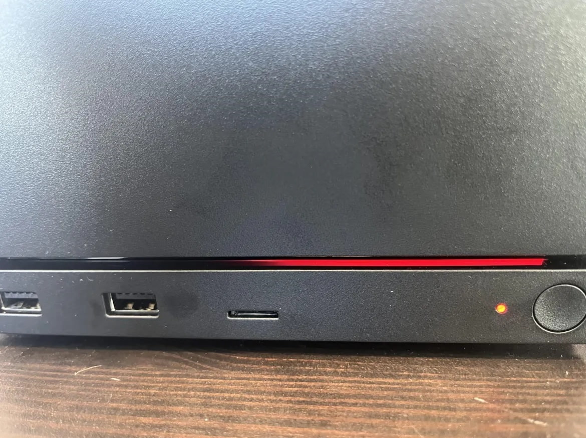 Steam Machine User Reports a Flashing Red Front Panel of a Black Device with Two Usb Ports a Slim Card Reader Slot a Red Led Accent and a Circular Powervolume Knob on the Right