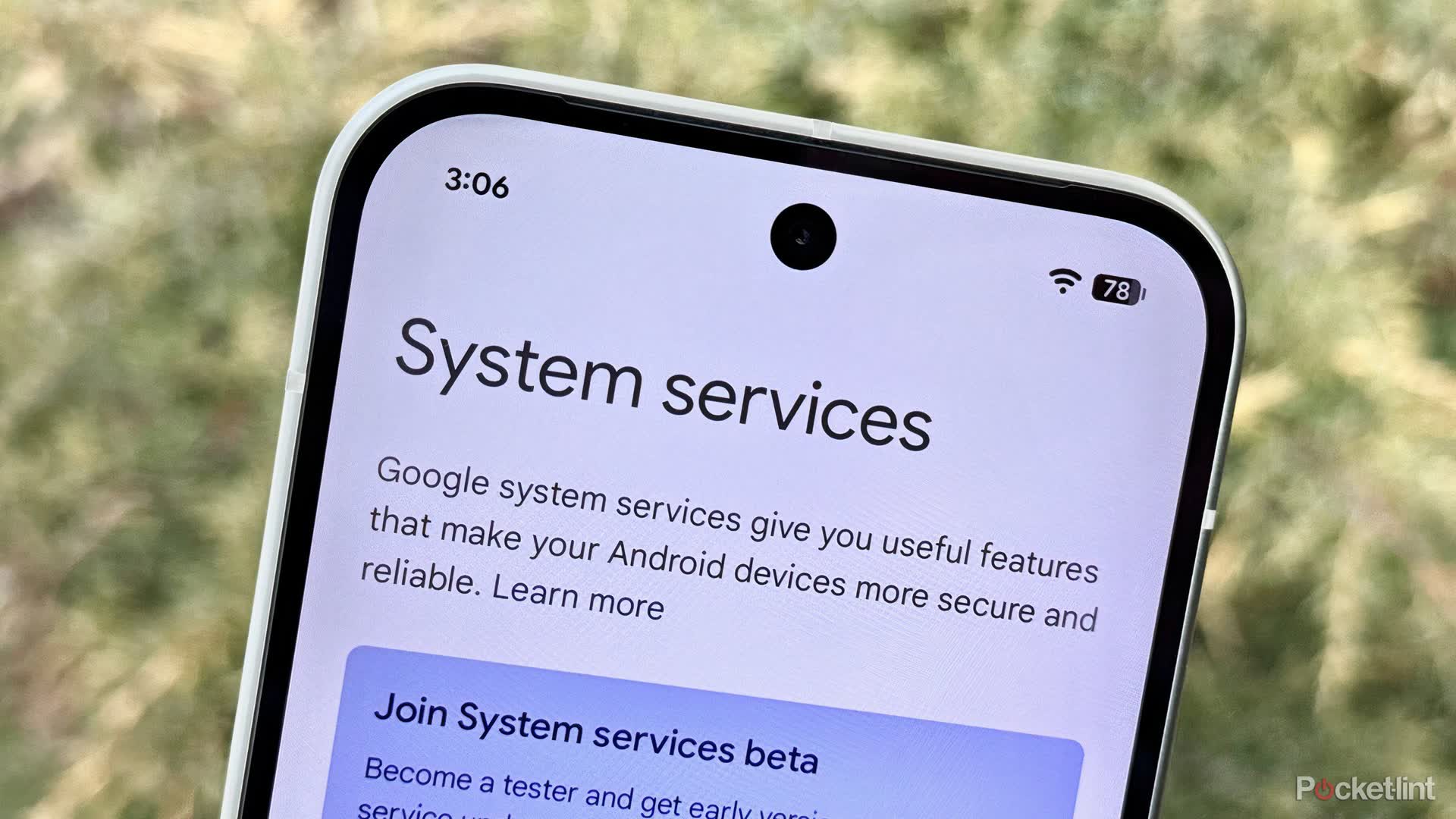Close-up of a smartphone screen showing the Android 'System services' settings page with text about Google system services.